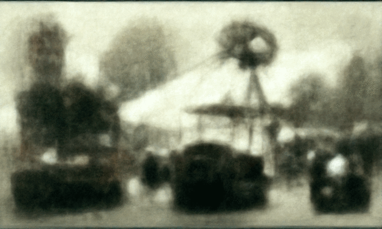 a grainy old looking black-and-white photograph of what seems to be a carnival